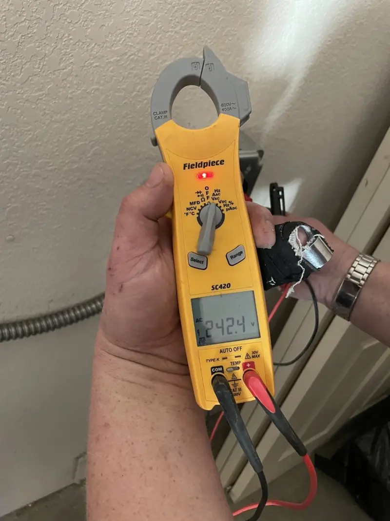 Voltage testing with clamp meter during Ceiling Fan Installation in Shelburne